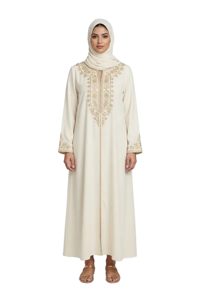 A woman in an ivory jalabiya with gold embroidery and a light hijab
